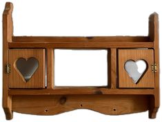 a wooden shelf with mirrors and hearts on it