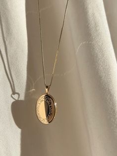 An oval locket with a floral border is placed on our 0.6mm Box Chain. Layer for effect (we recommend) or wear on its own. Always made in 100% 14k gold. Oval Locket, Floral Border, Locket Necklace, Box Chain, Gold Pendant, Locket, Vintage Inspired, Chain, Pendant