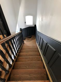 the stairs are made of wood and have black railings