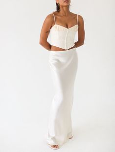 The Archive Bias skirt has an elasticized waist that can be worn high or low rise. It provides shape without sacrificing comfort. White Fitted Cropped Skirt, Feminine Fitted White Maxi Skirt, Elegant Cropped Flowy Skirt, White Fitted Maxi Skirt For Night Out, Chic Fitted Maxi Skirt With Elastic Waistband, Fitted Cream Bottoms For Night Out, Chic Cropped White Skirt, Fitted Feminine Gathered Maxi Skirt, Fitted Long Skirt In Off White