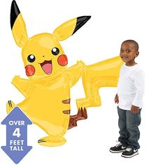 a little boy standing next to a balloon shaped like a pikachu