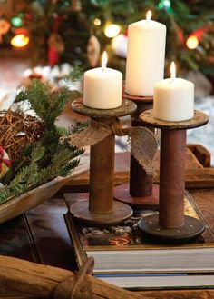 three candles are sitting on a tray with christmas decorations