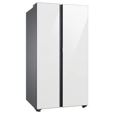 a white and black refrigerator freezer sitting on top of a floor next to a wall