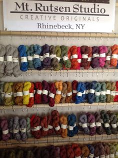 there are many skeins of yarn on display