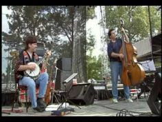 two men are playing instruments on stage