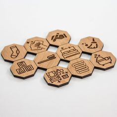 six wooden hexagonal magnets with different symbols on them