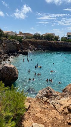 many people are swimming in the blue water