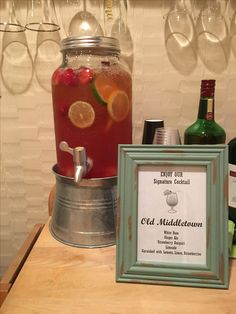 an old - fashioned cocktail is served in a bucket with a plaque on the table