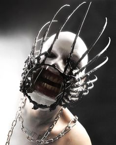 a woman with chains around her face and mouth