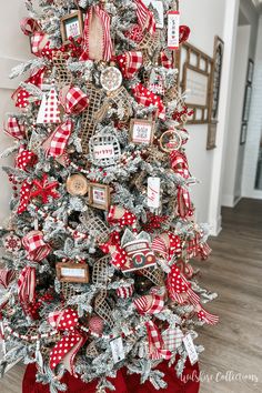 a christmas tree decorated with red and white ribbons