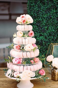 there is a cake made out of doughnuts and flowers on the top tier