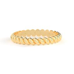 a yellow gold stacking ring on a white background