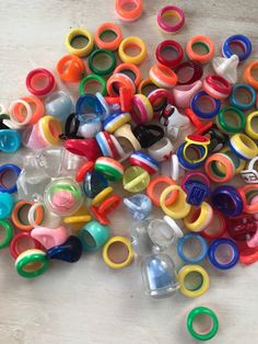 there are many different colored plastic rings on the table and one is broken in half