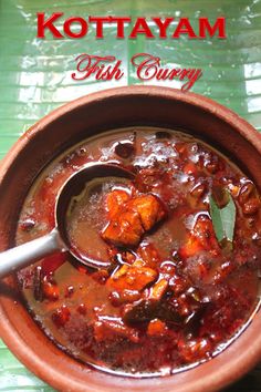 a bowl filled with stew sitting on top of a green table next to a spoon