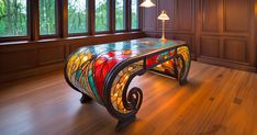 a stained glass table in the corner of a room with wood paneling and windows