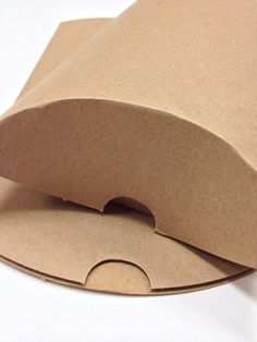 an open brown paper bag sitting on top of a white table