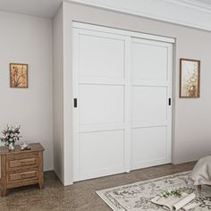 a bedroom with two white doors and a rug on the floor