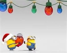 two minion characters wearing christmas lights and santa hats