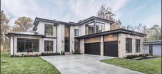 a large house with two garages in the front and one on the other side