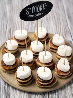 mini pancakes topped with marshmallows are arranged on a platter for an appetizer