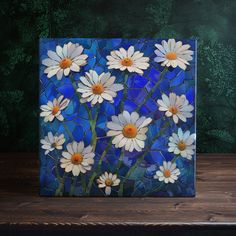 a painting of white daisies on a blue glass tile with trees in the background