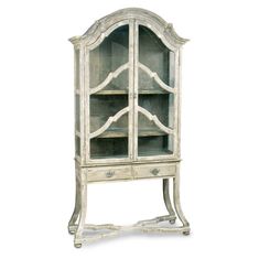 an old white china cabinet with glass doors