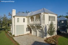 a large white house sitting on top of a lush green field