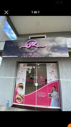 the front door of a beauty shop with an advertisement on it