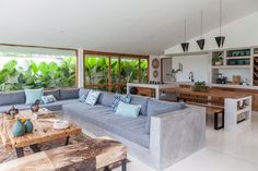 a living room filled with furniture and lots of windows