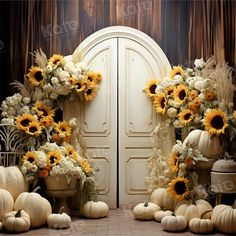 sunflowers and white pumpkins are arranged in front of an open door with fall decorations