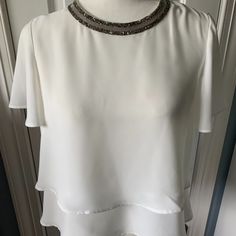 Two Layer White Blouse With Crystal Trim Around The Neckline. Nwot. Hits At About The Hip. Elegant Spring Blouse With Overlay, White Short Sleeve Evening Blouse, Elegant Short Sleeve Blouse For Night Out, White Short Sleeve Tops For Evening, Elegant White Blouse For Layering, Elegant Zara Tops For Layering, Elegant Party Blouse With Overlay, White Short Sleeve Blouse For Party, Zara Short Sleeve Blouse For Night Out