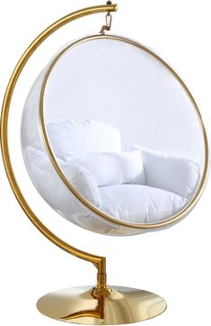 a white and gold hanging chair in the shape of an egg with pillows on it