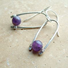 Unique amethyst statement earrings. My signature inverted hoops in silver with a luscious purple amethyst nestled within, Made from sterling silver that's been hand formed and forged, then buffed to a nice sheen. The silver inverted hoops are about 1 inch by themselves (not including the earwires). Please see measurement photo to get an accurate idea of the size of these earrings. You can enter my main shop here: http://www.etsy.com/shop/ArtistiKat Photos and content © K Davis Studios PLEASE rea Modern Purple Gemstone Earrings, Modern Purple Jewelry As A Gift, Modern Purple Jewelry For Gifts, Modern Amethyst Earrings As Gift, Everyday Purple Jewelry With Ear Wire, Modern Purple Dangle Jewelry, Modern Purple Amethyst Jewelry, Purple Amethyst Jewelry With Ear Wire, Purple Round Hoop Earrings As Gift