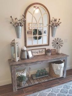 an entryway with a mirror, vases and other items