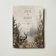 a wedding card with an image of a deer and pine trees in the background, on a white wall