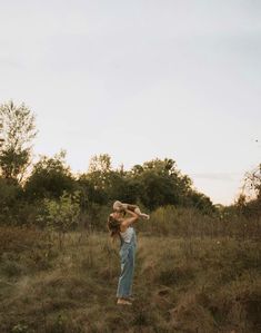 a woman standing in the middle of a field