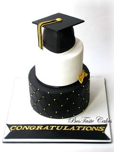 a graduation cake is decorated with black and white fondant, gold trimmings