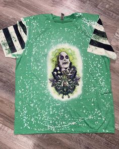 Bleached Beetlejuice Beetlejuice Beetlejuice front and back shirt. Beetle Juice Shirts, Beetlejuice Shirt Ideas, Cotton Tops With Character Print For Alternative Fashion, Casual Green Halloween Top, Casual Acid Wash Tops For Halloween, Themed Green Crew Neck Top, Green Themed Crew Neck Top, Halloween Acid Wash Skull Print Top, Green Themed Cotton Tops