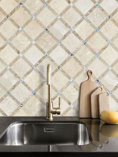 a kitchen counter with a sink and cutting board