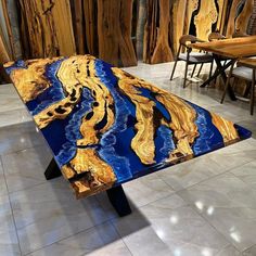 a blue and yellow table sitting on top of a tiled floor