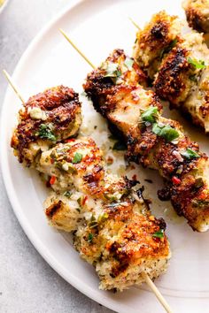 chicken skewers on a white plate with toothpicks