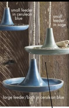 two blue bird feeders hanging from the ceiling