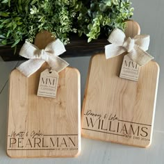 two personalized cutting boards with bows on them