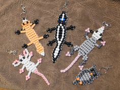 four beaded key chains with different designs on them