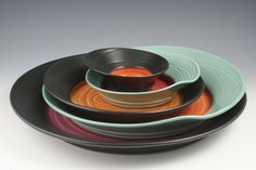 a stack of colorful plates and bowls on top of each other