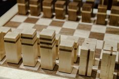 several pieces of wood sitting on top of a chess board