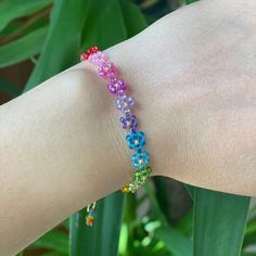 Rainbow coloured bead bracelet with a delicate design. The Floral Daisy Bracelet will brighten up your look. A beaded bracelet crafted by hand with high-quality beads. Galvanized gold beads and shiny beads are used to embellish it. Thank you very much for visiting our shop. We hope you have a great shopping experience! If you are struggling to find the information you need, please feel free to contact us. Do not forget to take a look at our other products in our shop. 😊 ➡️ Matching necklace: ⬇️ Multicolor Trendy Bracelet With Flower Charm, Trendy Multicolor Bracelet With Flower Charm, Trendy Multicolor Bracelets With Flower Charm, Multicolor Flower Shaped Spacer Beads, Colorful Flower-shaped Bracelets For Gifts, Colorful Flower Bracelets For Gifts, Colorful Flower Bracelets As Gift, Multicolor Flower Friendship Bracelets, Adjustable Rainbow Beaded Bracelets For Spring