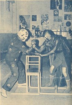 an old photo of two people playing with each other