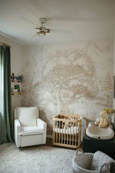 a baby's room with a crib, rocking chair and wallpaper on the walls