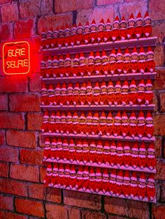 a red neon sign on the side of a brick wall